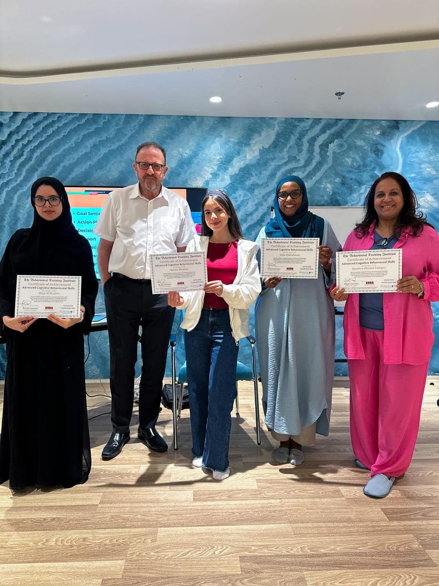 Dr. John Crimmins with four graduates holding Advanced Cognitive Behavioural Skills certificates