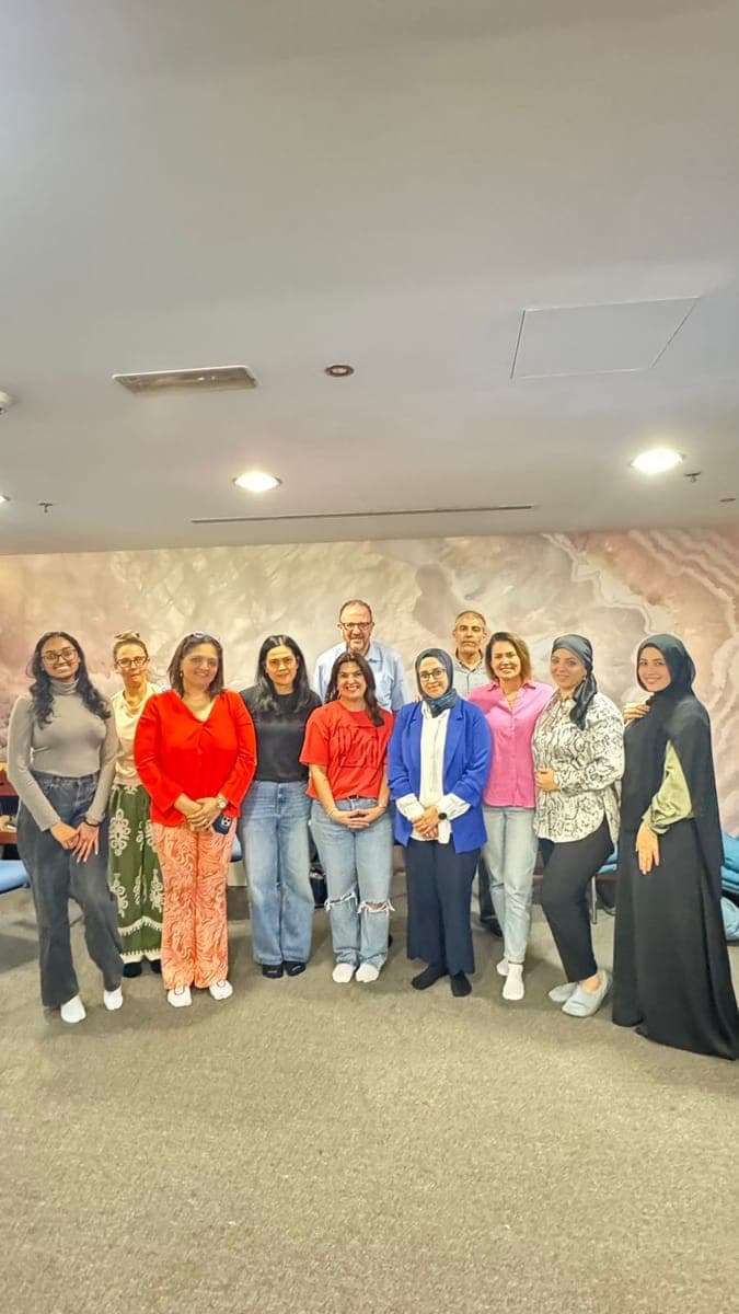 Diverse group of eleven workshop participants with Dr. John Crimmins representing multiple nationalities