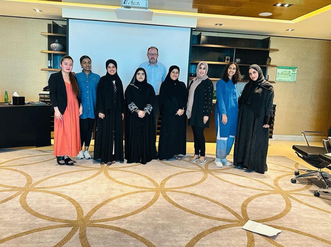 Dr. John Crimmins with workshop participants at a luxury five-star hotel venue in Dubai